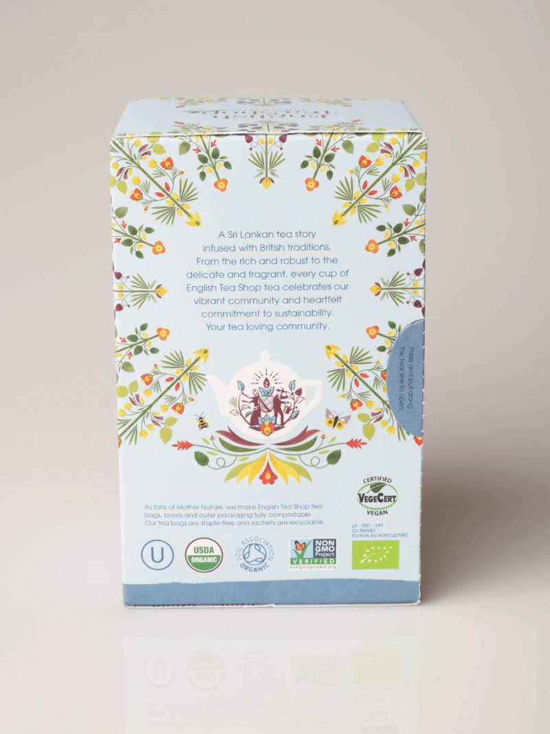 Pastelfarvet Energise Me teæske med blomsterillustration, beskrivende tekst og økologiske certificeringslogoer